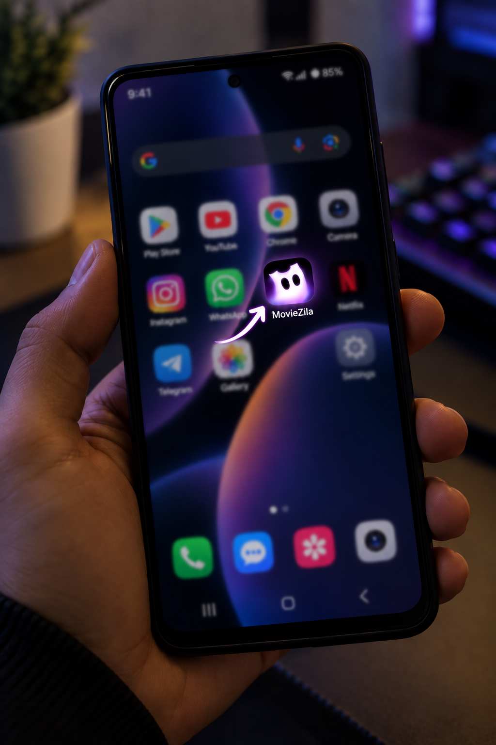 Opening the MovieZila app on an Android smartphone — tapping the MovieZila app icon to launch the free streaming app from the phone home screen, step 1 to start streaming with MovieZila